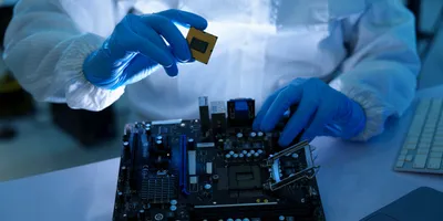 Scientist in cleanroom preparing semiconductor for research