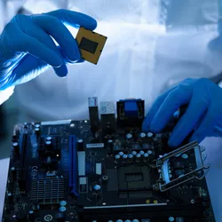 Scientist in cleanroom preparing semiconductor for research