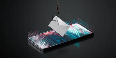 A fishhook pierces a paper envelope hovering above a smartphone screen displaying colorful digital code, symbolizing a phishing cyberattack targeting mobile devices and sensitive data.