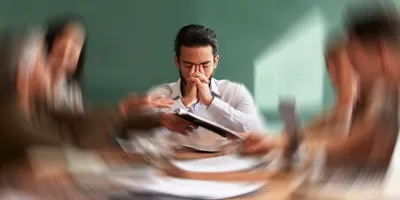 Stressed lab manager during a team meeting