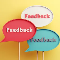 Three speech bubbles displaying the word 'Feedback' against a yellow background