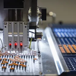 Close-up of an automated robotic system sorting capped sample vials into trays in a laboratory setting, highlighting sample management automation.