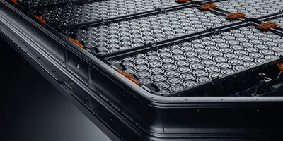 close up of ev battery pack with orange connectors isolated on black background