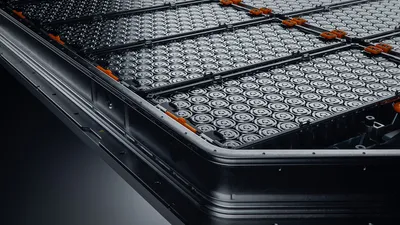 close up of ev battery pack with orange connectors isolated on black background
