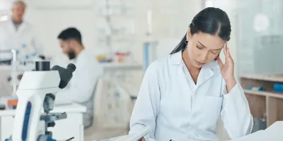 Middle manager in a lab appearing distressed