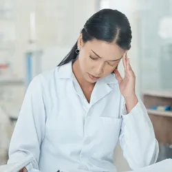 Middle manager in a lab appearing distressed