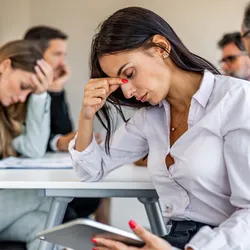 Stressed team meeting with one member showing concern