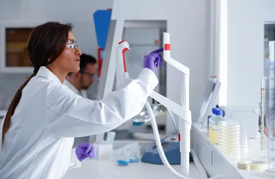 Woman in lab coat using a touch screen