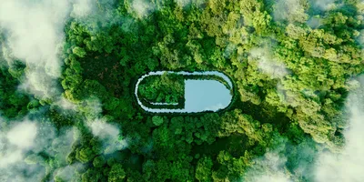 Aerial view of lush green forest and lake symbolizing lab sustainability efforts