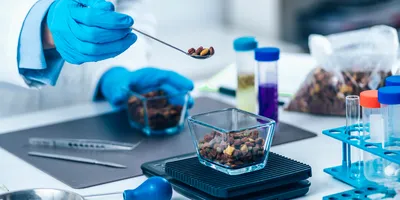 Scientist performing quality control test on a food product as part of proficiency testing