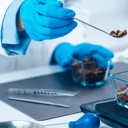 Scientist performing quality control test on a food product as part of proficiency testing