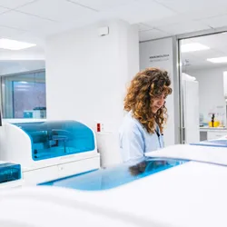 Lab professional reviewing automated syphilis testing workflow results at clinical analyzer workstation