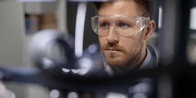 Focused researcher using lab equipment for scheduling.