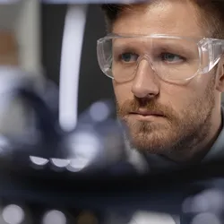 Focused researcher using lab equipment for scheduling.