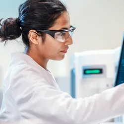 Laboratory professional navigating AI tools at workstation