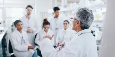 Lab leadership development with team discussion in laboratory setting.