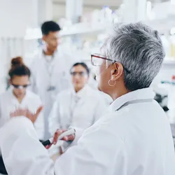 Lab leadership development with team discussion in laboratory setting.