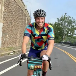 Stephen Miller, director of product design at MachineQ, wearing a helmet and riding a bicycle