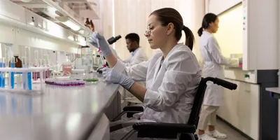 Scientist in a wheelchair working in a disability-inclusive laboratory