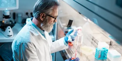 Scientist conducting laboratory work in a ventilated space.