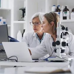 Researchers collaborating in a lab on computing projects related to Canada Global Impact+ initiative