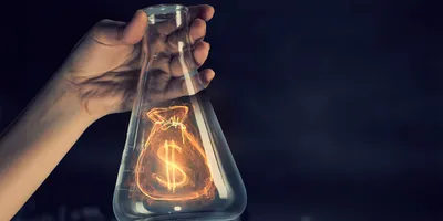 Flask with a dollar sign, symbolizing financial support for research initiatives.