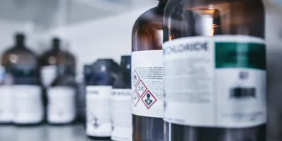 Chemical bottles with hazard label in a laboratory