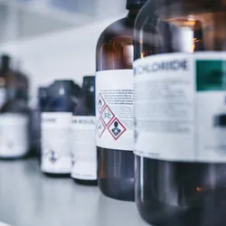 Chemical bottles with hazard label in a laboratory