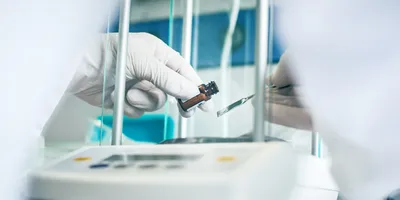Scientist handling a vial during measurement process