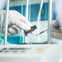 Scientist handling a vial during measurement process