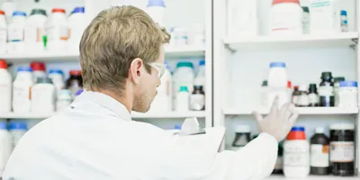 Scientist examining jars in lab