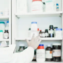 Scientist examining jars in lab