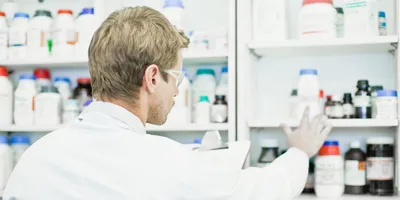 Scientist examining jars in lab
