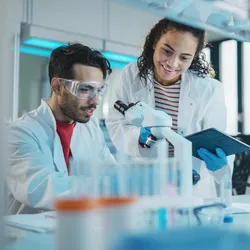 Participants working with laboratory equipment for STEM education.