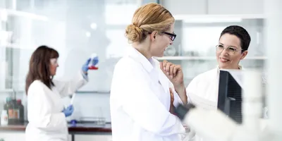 Lab staff discussing research and fostering trust in the lab