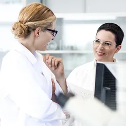 Lab staff discussing research and fostering trust in the lab