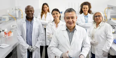 Multigenerational team of lab professionals collaborating