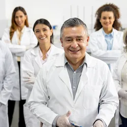 Multigenerational team of lab professionals collaborating