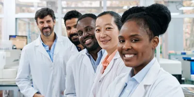 Diverse professionals in a laboratory, reflecting people-first leadership principles