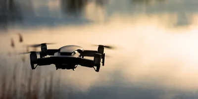 A drone flying above water symbolizing a lab-on-a-drone nitrate monitoring system
