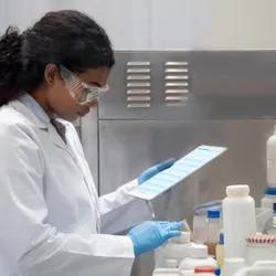 Laboratory worker analyzing safety data for SIF prevention