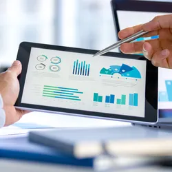 Person analyzing KPIs on a tablet