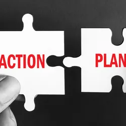 Two hands connecting puzzle pieces labeled 'ACTION' and 'PLAN' for crisis management