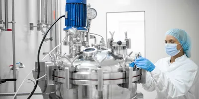 Scientist working on biopharma manufacturing equipment