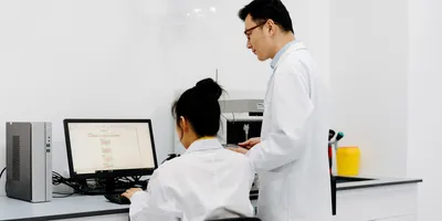 Staff in a lab setting engaged in discussion, addressing turnover challenges.