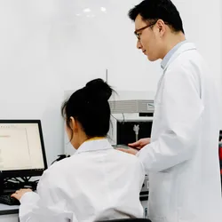 Staff in a lab setting engaged in discussion, addressing turnover challenges.