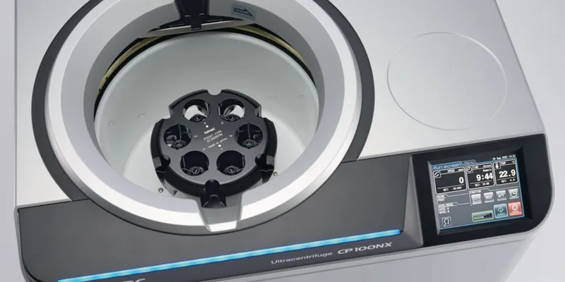 Top-down view of the himac CP100NX Ultracentrifuge showing the internal chamber with a P32ST rotor installed. The image highlights the tool-free, self-locking rotor system and the large touch screen interface used for visual balancing and rotor lifetime management.