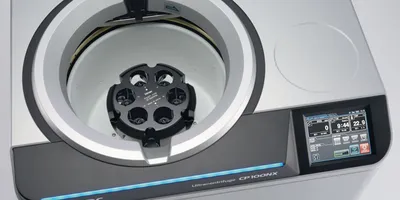 Top-down view of the himac CP100NX Ultracentrifuge showing the internal chamber with a P32ST rotor installed. The image highlights the tool-free, self-locking rotor system and the large touch screen interface used for visual balancing and rotor lifetime management.