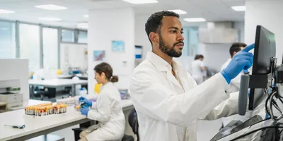 Lab technician operating equipment in a central laboratory