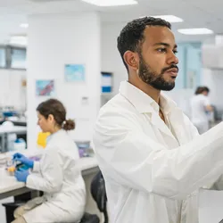 Lab technician operating equipment in a central laboratory